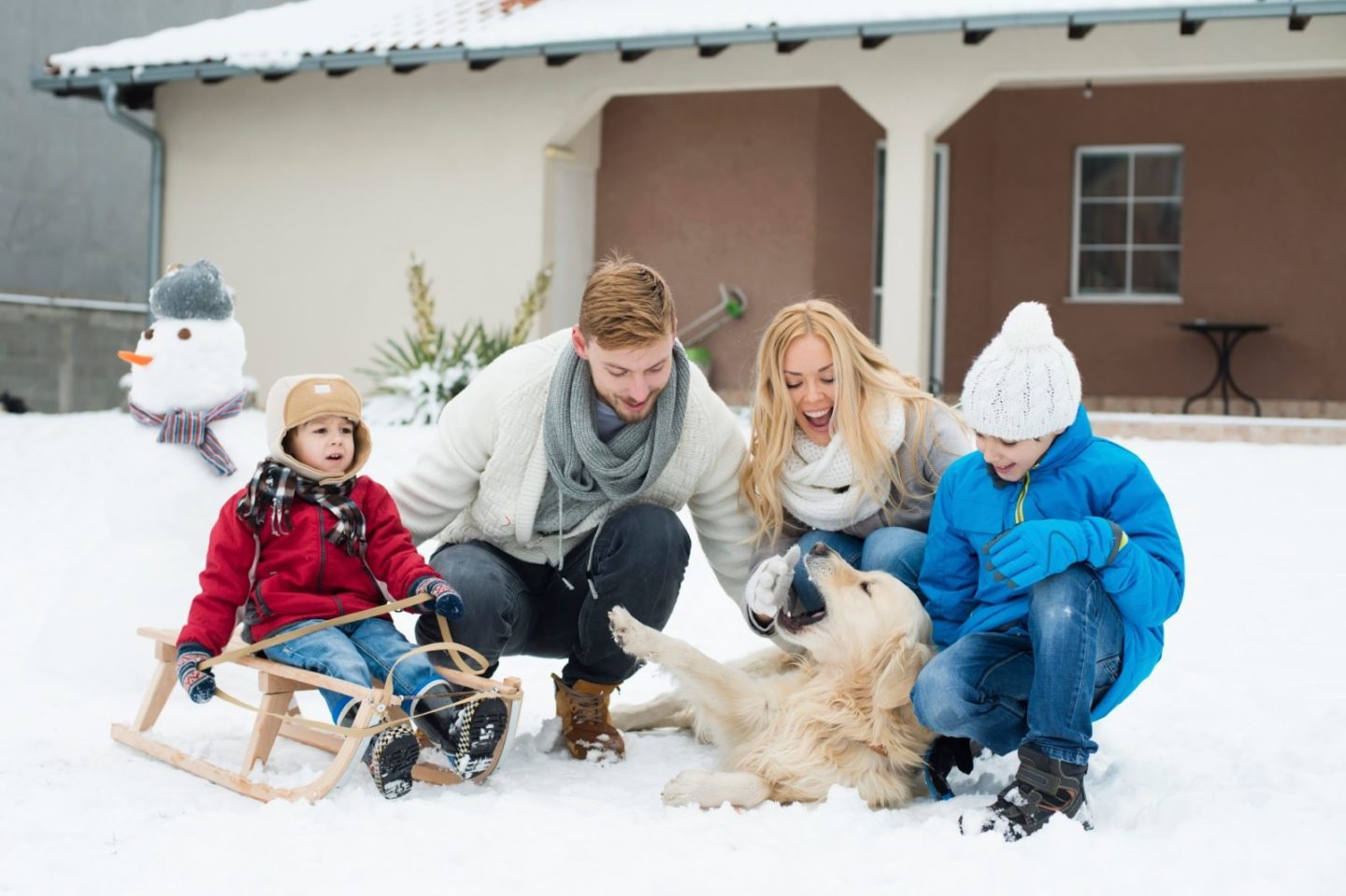 winter_family_with_dog_in_front_of_house.jpg