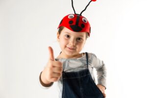 Child with ladybug hat on
