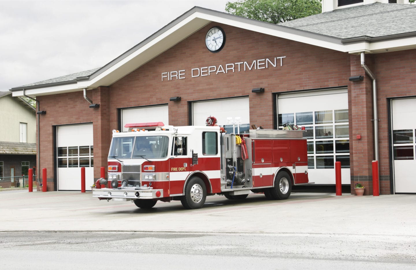 Fire truck outside fire house by Rose Pest Solutions