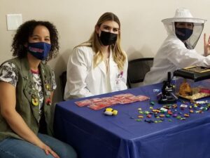 Rose Pest Solutions team with plastic bugs on table