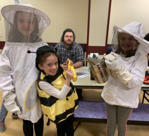 girl scouts dress up as bees and beekeepers