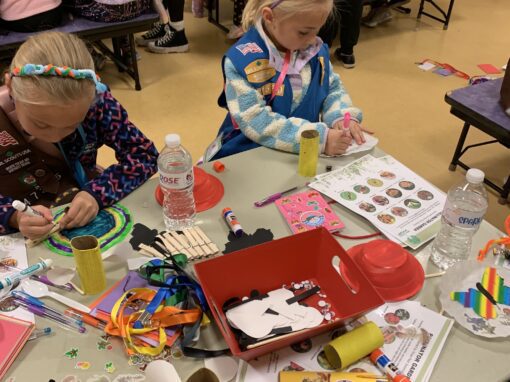 Girl Scouts doing insect-themed crafts