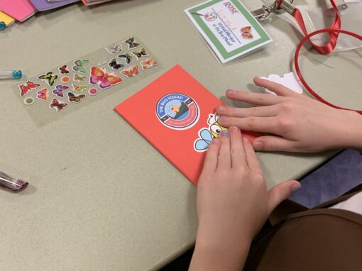 Girl Scouts decorating their field note books