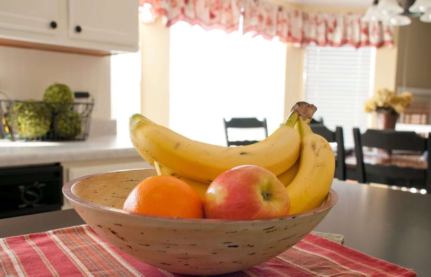 A bowl of fruit kept on the kitchen table of a house in Illinois