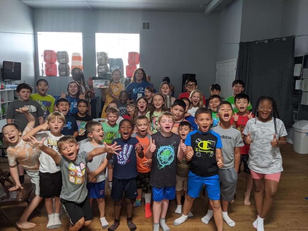 Team of Rose Pest Solutions with kids at a school in Illinois